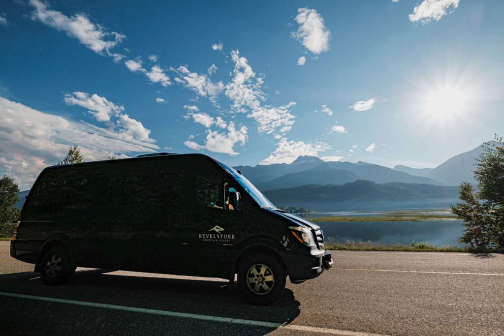 Revelstoke Transfers Van shuttling passengers around downtown Revelstoke in summer